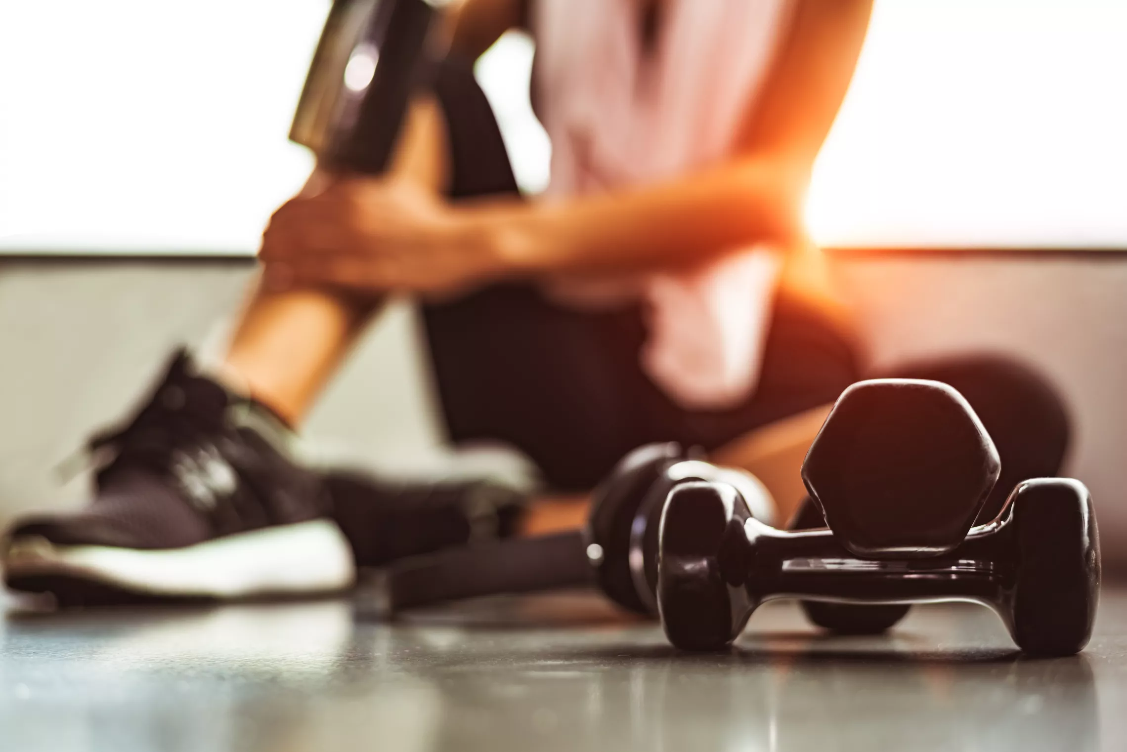 outline of woman and dumbbells